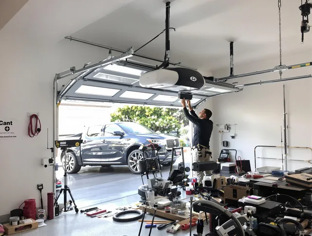 Torrington Garage Door Repair specialist installing smart garage door opener system in Torrington home