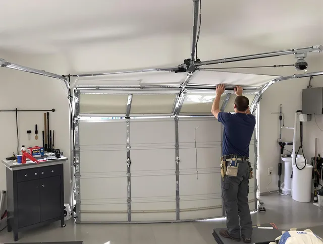 Torrington Garage Door Repair specialist performing precise section replacement on Torrington garage door